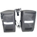 Pair of gray bike panniers with reflective strips on a white background