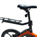 Close-up of a bicycle with a black seat and orange frame on a white background