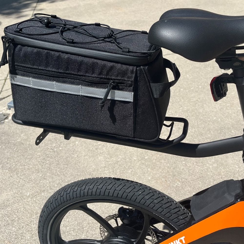Black bicycle bag attached to a bicycle with an orange frame.