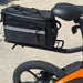 Black bicycle bag attached to a bicycle with an orange frame.